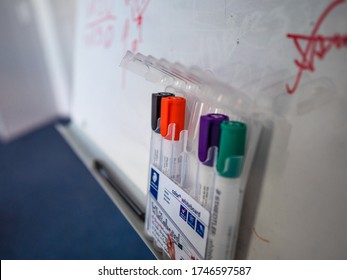 Whiteboard markers with a whiteboard in the background