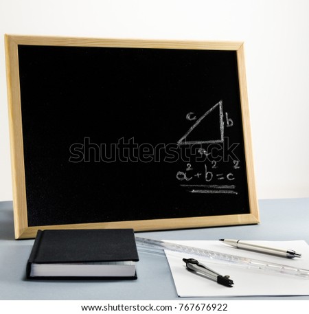 A whiteboard for teaching mathematics in school with the pythagorean theorem in graphical and mathematical formula form.