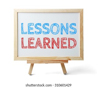 Whiteboard with text Lessons learned isolated on white background.