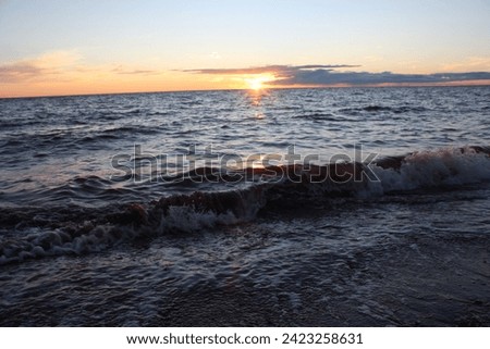 whitecap waves on beach at sunset