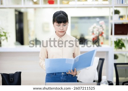 White-collar worker looking at documents carefully in the office