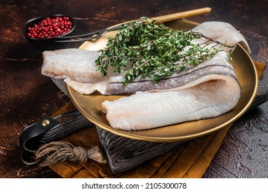 Whitefish Fillet, Raw Haddock Fish On Plate With Rosemary And Thyme. Dark Background. Top View