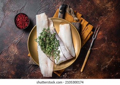 Whitefish Fillet, Raw Haddock Fish On Plate With Rosemary And Thyme. Dark Background. Top View