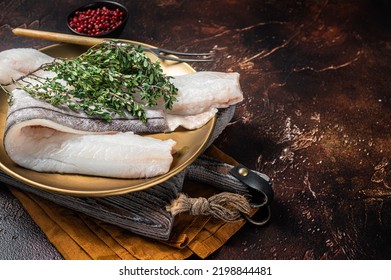 Whitefish Fillet, Raw Haddock Fish On Plate With Rosemary And Thyme. Dark Background. Top View. Copy Space.