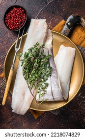 Whitefish Fillet, Raw Haddock Fish On Plate With Rosemary And Thyme. Dark Background. Top View.