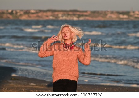 The white-haired girl fooling around on the beach. Enjoying life
