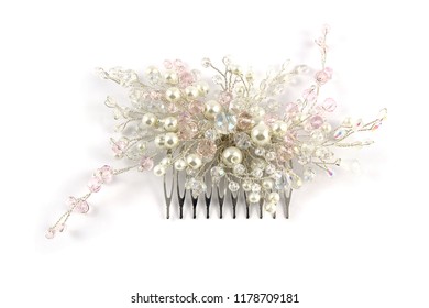 White-pink hair comb handmade from custom jewelry on the white background.