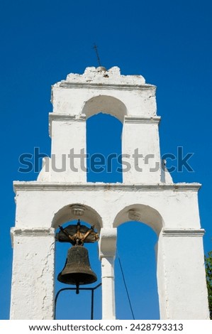 The whitewashed belltower of agios dimitrios against a clear blue sky, paxos, ionian islands, greek islands, greece, europe