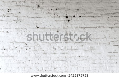 Whitewashed brick wall in an industrial ruin with clearly visible rough wall structure. Dirty, light factory background with dust, dirt and traces of a long history. Lost place in Germany.