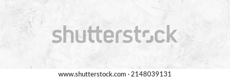 Whitewashed old rough concrete wall panoramic texture. White painted aged cement plaster surface. Light gray abstract grunge large background