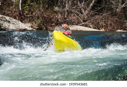 Whitewater Canoeist Busting Through A Rapid On A Beautiful Blue River 