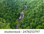 Whitewater Falls in Nantahala National Forest, North Carolina, USA. Beautiful landscape of high waterfall with falling down clear water from rocky boulders between green lush woods