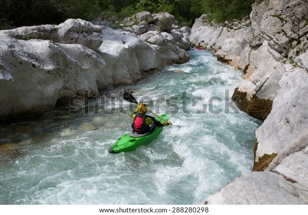 Whitewater kayaking down the\
rapids