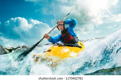 Whitewater kayaking, extreme kayaking. A guy in a kayak sails on a mountain river - Shutterstock ID 1170402781