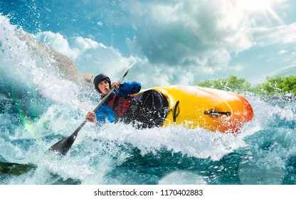Whitewater kayaking, extreme kayaking. A guy in a kayak sails on a mountain river - Shutterstock ID 1170402883