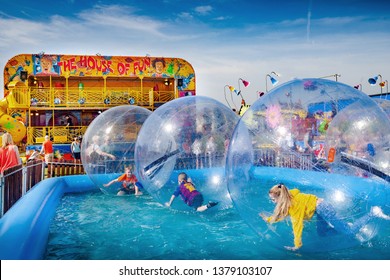 Whitley Bay, North Tyneside / England - April 21 2019: Giant Floating Zorb Balls On Water At The Spanish City Fun Fair In Whitley Bay, England.