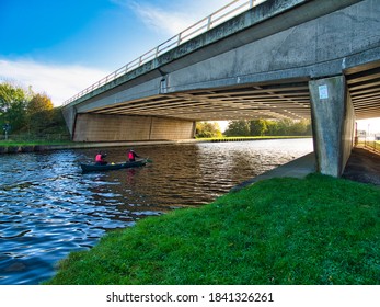 Whitley, North Yorkshire, England, Britain, October 2020, Two Man Canoe Travelling Along Aire And Calder Navigation Passing Under Bridge Carrying M62 Motorway