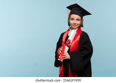 Whizz kid 9-11 year girl wearing graduation cap and ceremony robe with certificate diploma on light blue background. Graduate celebrating graduation. Education Concept. Successful elementary school - Shutterstock ID 2146197439