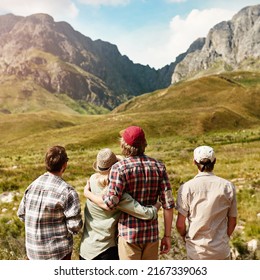 Who Better To Appreciate Nature Than With Your Best Mates. Rearview Shot Of A Young Couple Admiring A Mountainous View In Nature.