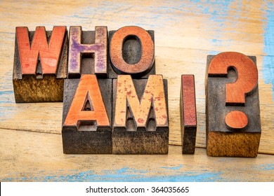 Who am I - a philosophical question spelled in vintage letterpress wood type printing blocks against grunge, painted wood - Shutterstock ID 364035665