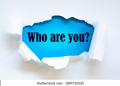 Who Are You? Question Written Under Torn Paper.