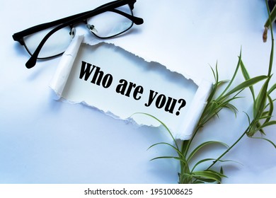 Who Are You? Question Written Under Torn Paper.