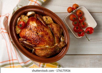 Whole baked chicken with garlic and cherry tomatoes