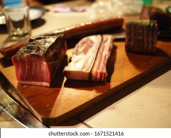 Whole Block Of Smoked Slab Bacon On A Rustic Wooden Tray