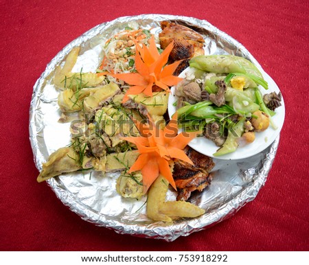 Whole boiled chicken on bamboo plate with kitchen foil