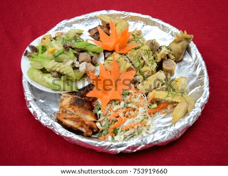 Whole boiled chicken on bamboo plate with kitchen foil