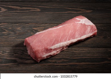 Whole Boneless Pork Loin Without Fat. Pork Tenderloin On A Dark Table