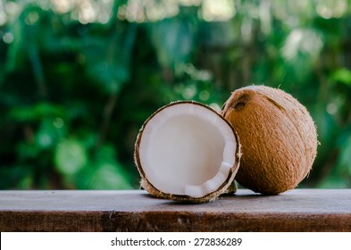 Whole and broken coconut on the table