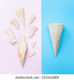 Whole And Broken Waffle Cone For Ice Cream On A Pink And Blue Background. Top View. Flat Lay.