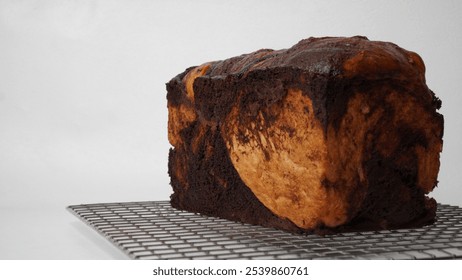 Whole brownie babka bread served using a cooling rack with a white background (isolated white). - Powered by Shutterstock