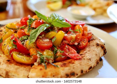 Whole Bruschetta Pizza With Lots Of Roma And Cherry Tomatoes 