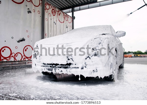 The\
whole car in foam and detergent bubbles at the\
sink