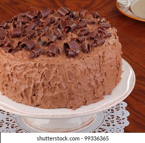 Whole Chocolate Cake With Chocolate Curl Toppingon A Cake Platter