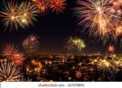 Whole city celebrating the New Year or any national event with fantastic multi-colored fireworks, copyspace on the night sky - Shutterstock ID 167370893