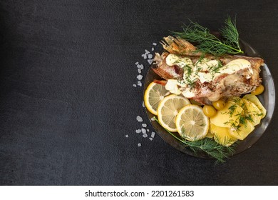 Whole Cooked Sebastes Fish With Fried Potatoes And Lemon On A Plate