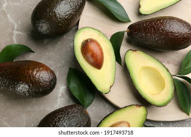 Whole And Cut Avocados On Grey Marble Table, Flat Lay