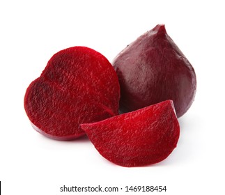 Whole and cut boiled red beets on white background