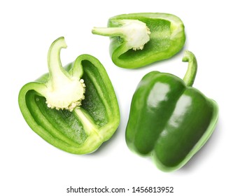 Whole and cut green bell peppers on white background, top view