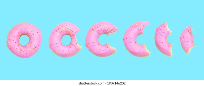 whole donut and half-eaten donuts with pink glaze and colored sprinkles on blue background Clipping path. Flat lay. Top view - Powered by Shutterstock