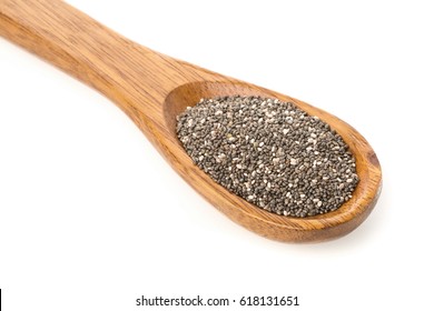 Whole Dried Black Chai Seeds In Wooden Spoon On White Background