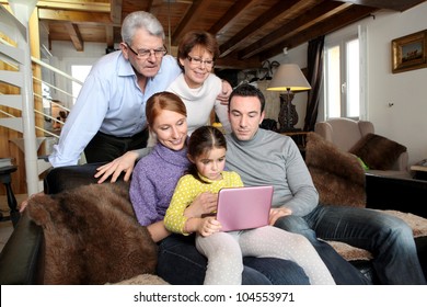 Whole Family Around A Laptop