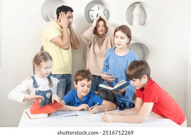 The whole family is doing their homework. Parents are shocked by the amount of homework and the modern education system - Powered by Shutterstock