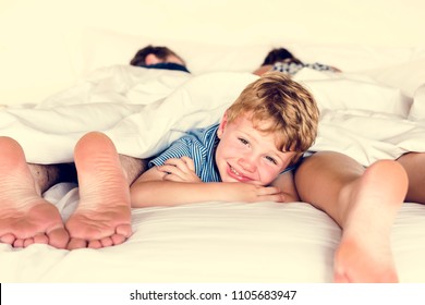 Whole Family Sharing A Bed