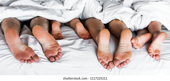 Whole Family Sharing A Bed