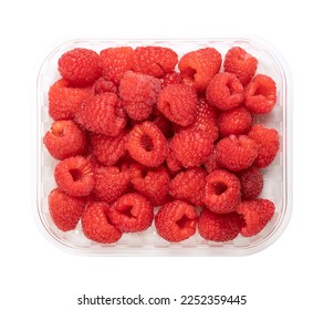 Whole fresh raspberries, in a clear plastic punnet, from above. Ripe, red and sweet fruits of Rubus idaeus, the cultivated European raspberry. Organic and vegan fruits. Isolated, close-up, food photo.