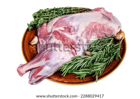 Whole fresh Raw goat shoulder meat on a plate. Isolated on white background